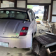 A Toyota WiLL Vi and a WiLL Vi-sized hole in the door of a 15th-century Japanese communal toilet